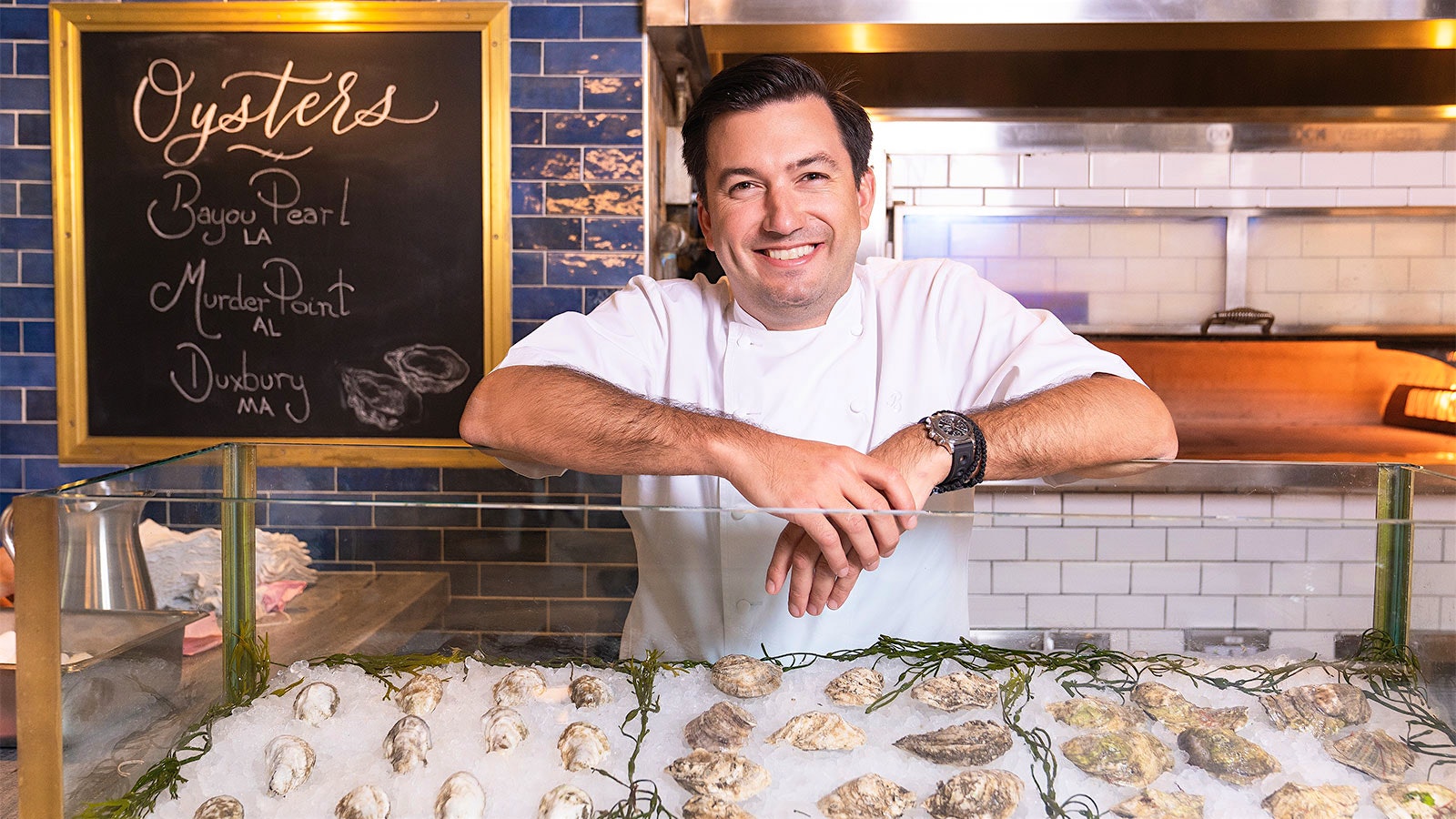  Portrait of chef Aaron Bludorn behind a display of oysters at one of his Houston restaurants